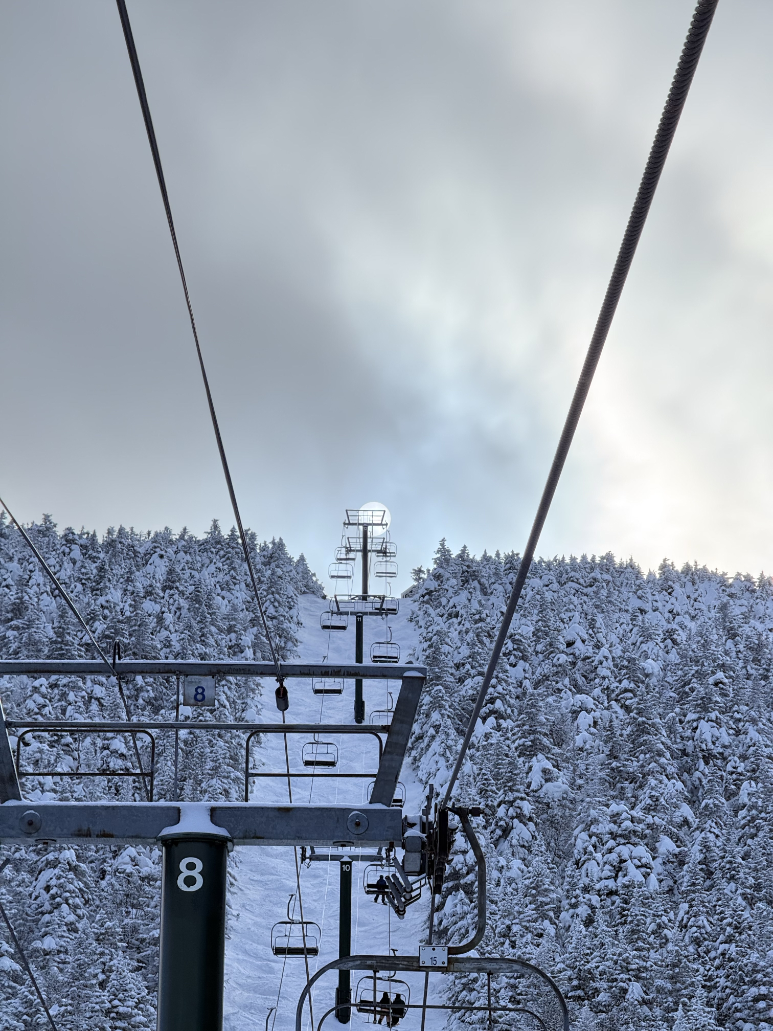 Renua Energy team going up the ski lift at Sugarbush Resort with mountain views and snowy slopes